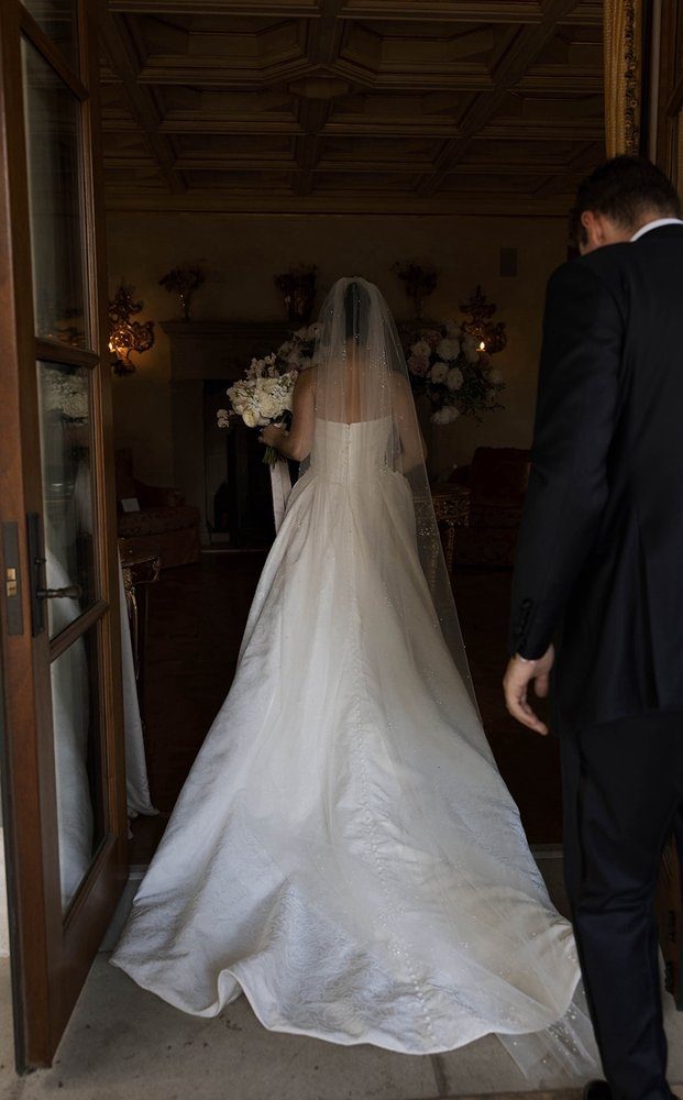The back of a gown with a full length veil falling over the train