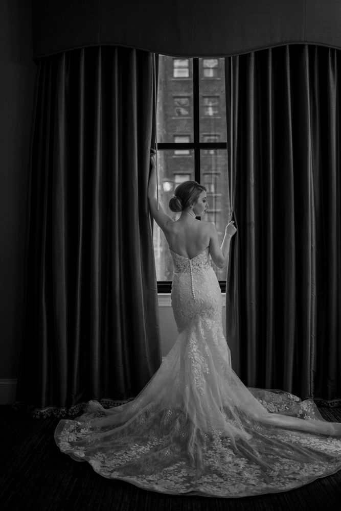 A fitted lace gown from behind, in black and white